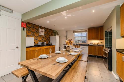 a large kitchen with a wooden table in it at Next to Brighton Beach I Super central Big House in Brighton & Hove