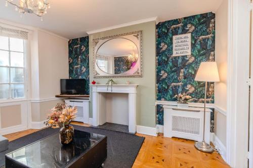 a living room with a fireplace and a mirror at Next to Brighton Beach I Super central Big House in Brighton & Hove