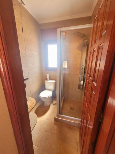 a bathroom with a toilet and a glass shower at casa des loups in Ciudad Quesada