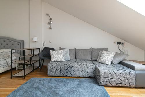 a living room with a couch and a table at Vilnius Old Town Happiness in Vilnius