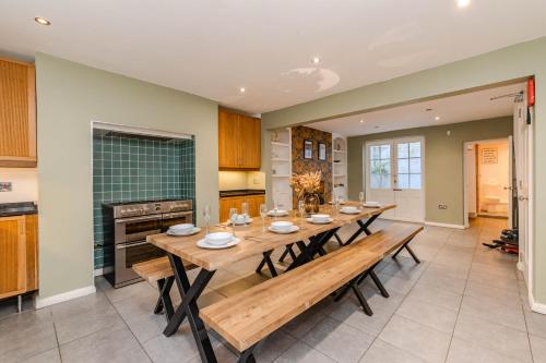 a kitchen with a long wooden table in a room at Super Central Town House Next To Brighton Beach in Brighton & Hove