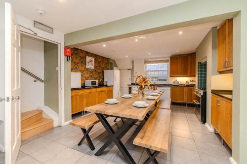 a kitchen with a wooden table in a room at Super Central Town House Next To Brighton Beach in Brighton & Hove