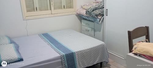 een kleine kamer met 2 bedden en een dressoir bij Casa Denis in Pântano Grande