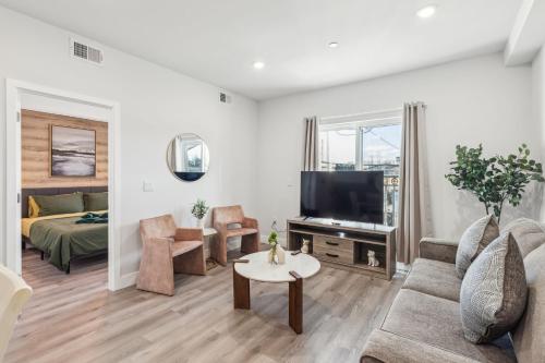 a living room with a couch and a tv at Stay at Luna on 800 Callowhill in Philadelphia