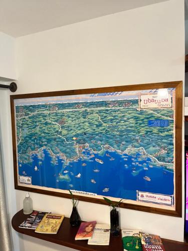 a large monitor hanging on a wall at Apartamento Matteo in Ubatuba