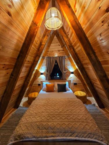 a bedroom with a bed in a attic at Villas Sunny Hill in Žabljak