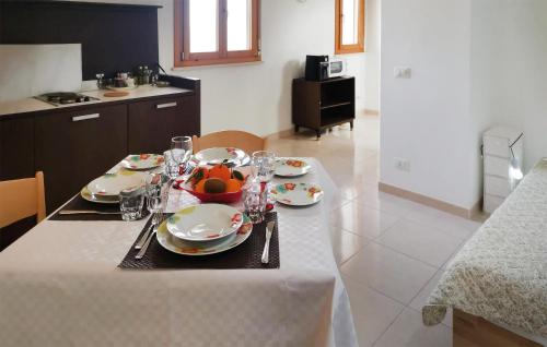 a table with plates and glasses on it in a kitchen at Awesome Apartment In Ragusa With Wifi in Ragusa