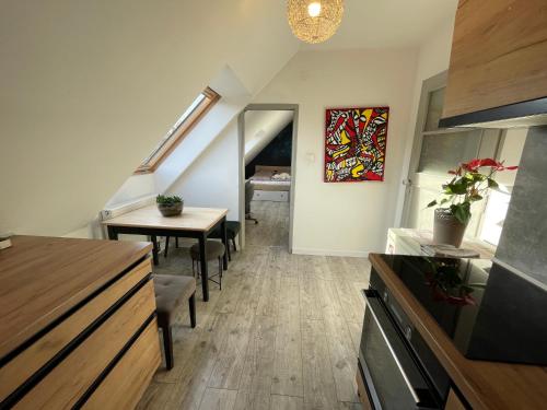 a living room with a staircase and a table and chairs at Apartmán Kubín in Dolný Kubín