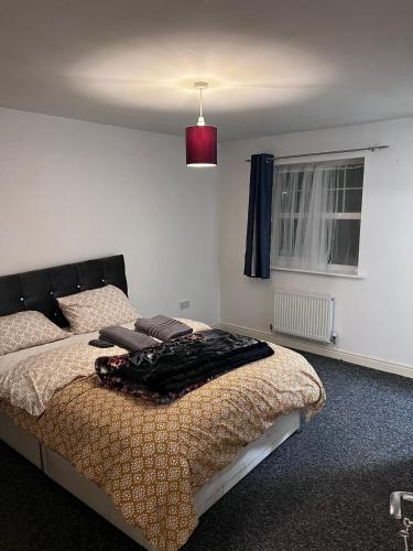 a bedroom with a bed with a blanket on it at Mekees Luxury Apartment in Tipton