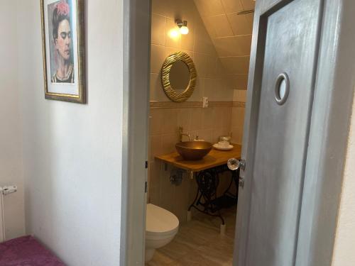 a bathroom with a sink and a toilet and a mirror at Apartmán Kubín in Dolný Kubín
