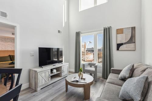 a living room with a couch and a tv at Stay at Luna on 800 Callowhill in Philadelphia