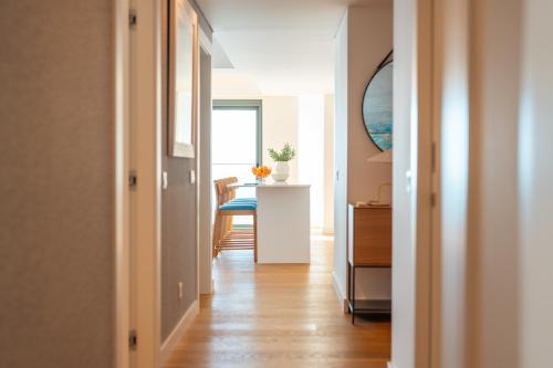 a hallway with a room with a table and a table at Suite 5P Madeira Acqua Residence in Funchal