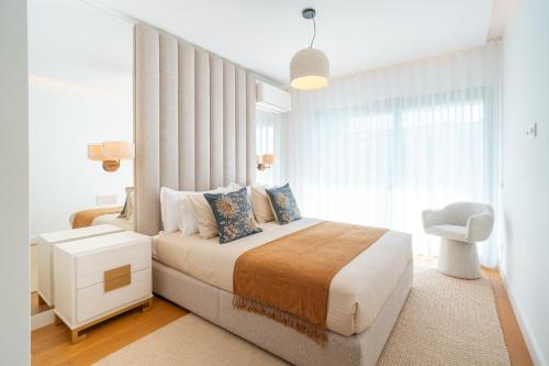 a bedroom with a large bed and a window at Suite 5P Madeira Acqua Residence in Funchal