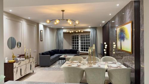 a living room with a dining table and a couch at Luxury One Bed Apartment Goldcrest Grand Mall and Residency DHA LHR in Lahore