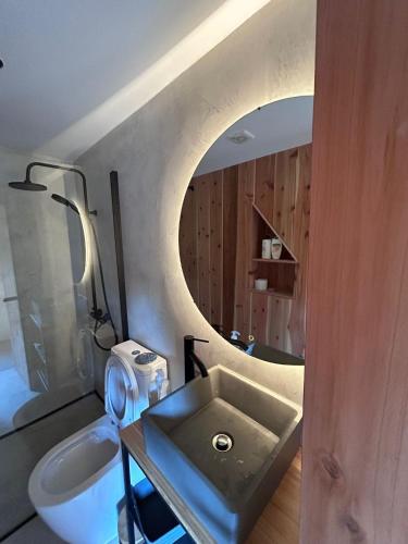 a bathroom with a sink and a mirror at Casa 3 Picos 2 in São Roque do Pico