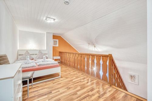 a bedroom with a bed and a wooden floor at Galerie-Apartment am Kurgarten in Bad Reichenhall