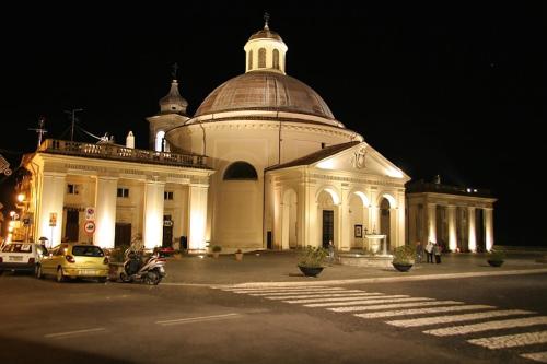 a large white building with a dome on top at night at Villa Abbamer in Grottaferrata