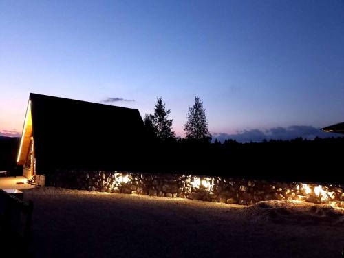 a barn lit up at night with lights at Villas Sunny Hill in Žabljak
