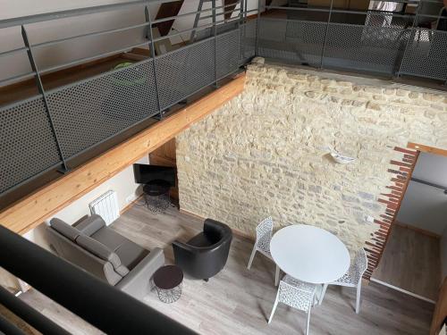 an overhead view of a living room with a table and chairs at Chez colette in Commes