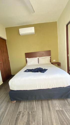 a bedroom with a bed with white sheets at REGMAR Progreso Yucatán in Progreso