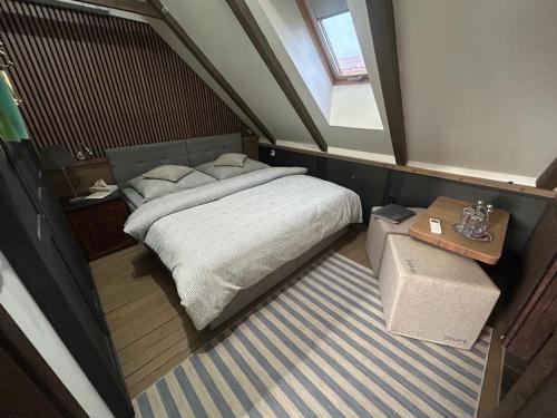a small bedroom with a bed and a window at DVOR 13 Hokovce in Hokovce
