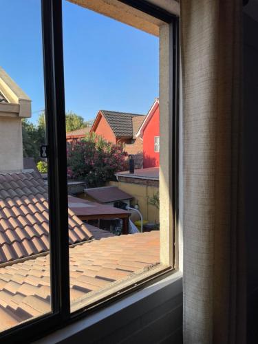 a window with a view of a wooden deck at Hostal Brisa Serena in Santiago