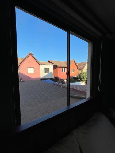 a window in a bedroom with a view of a courtyard at Hostal Brisa Serena in Santiago