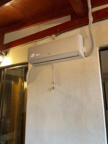 a white appliance hanging from a wall in a room at Hostal Brisa Serena in Santiago