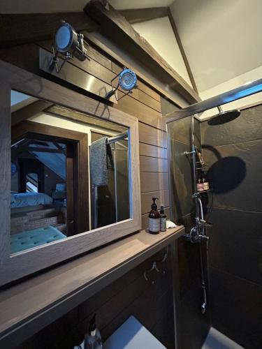 a bathroom with a large mirror and a shower at DVOR 13 Hokovce in Hokovce