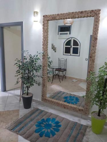 a mirror in a room with a table and a chair at Cute affordable apartment in Marrakech
