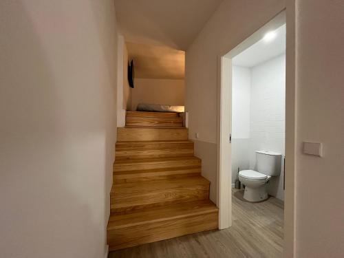 a hallway with a stairs leading to a bedroom at Romantic Downtown Studio in Vila do Conde