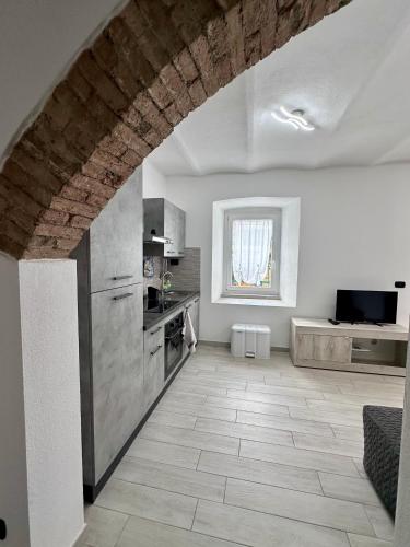 a kitchen with white walls and a brick ceiling at Casa Nemo - Golfo Paradiso in Recco