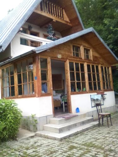 a house with glass doors and a porch at Eva's Garden in Breaza