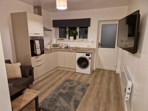 a kitchen with a washing machine in a living room at Highbanks in Newhaven