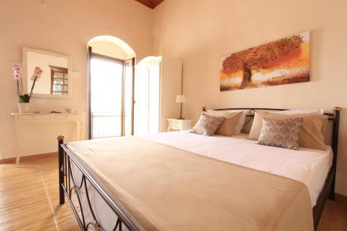 a bedroom with a large bed in a room at Athanasia's House in Symi