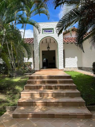 a white building with stairs leading to a doorway at PASEOS GRANDES!!!-14 PAX-Hacienda Manantiales Paraíso Natural in Fredonia