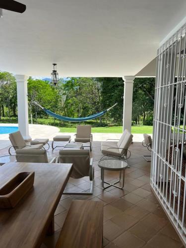 a living room with chairs and tables and a pool at PASEOS GRANDES!!!-14 PAX-Hacienda Manantiales Paraíso Natural in Fredonia