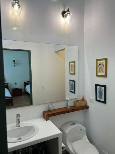 a bathroom with a sink and a toilet and a mirror at PASEOS GRANDES!!!-14 PAX-Hacienda Manantiales Paraíso Natural in Fredonia