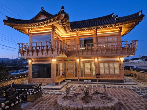 a large building with a balcony on top of it at Hanok Stay Seowa in Gyeongju