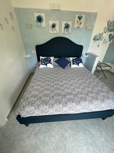 a bedroom with a large bed with pillows on it at Casa Maria Grazia Camera vista mare in Anacapri