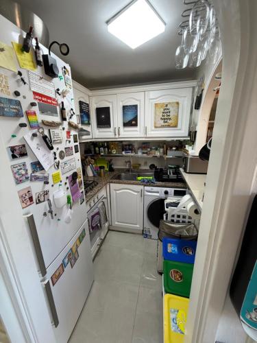 a kitchen with a white refrigerator with many magnets at FLAT Surrounded by Nature WIFI & Pool & beach Nearby in Son Parc