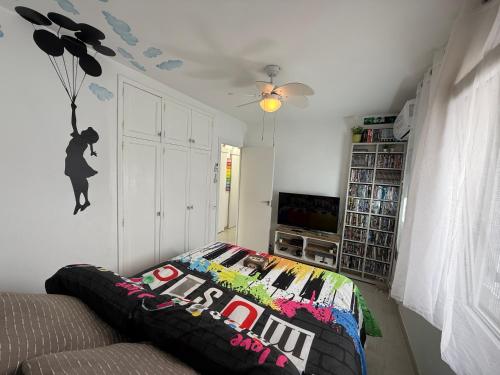 a living room with a bed and a tv at FLAT Surrounded by Nature WIFI & Pool & beach Nearby in Son Parc