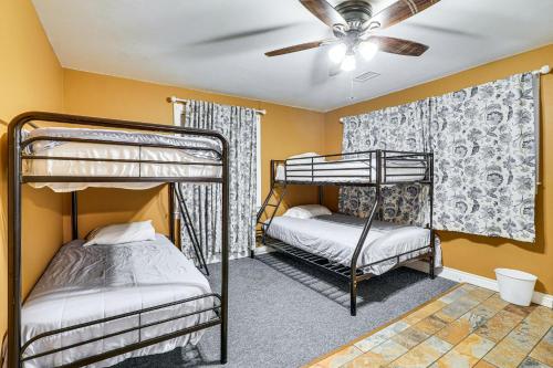 a bedroom with two bunk beds and a ceiling fan at Less Than 1 Mi to Main St Berryville Spacious Family Home in Berryville