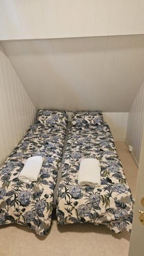 a bed in a room with two pillows on it at Large House in Central Stavanger in Stavanger