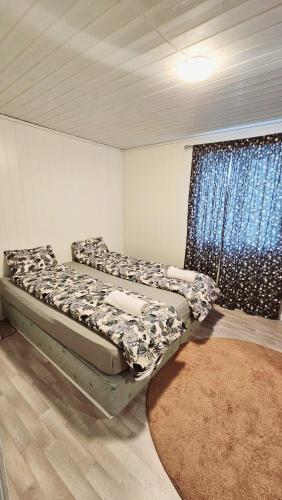 a bedroom with two beds in a room with a window at Large House in Central Stavanger in Stavanger