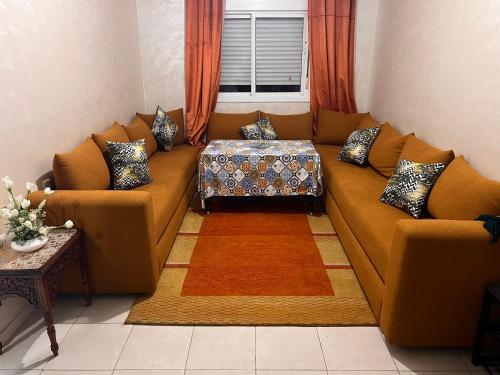 a living room with a couch with pillows at Appartement de luxe in Casablanca