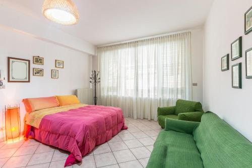 a bedroom with a bed and a couch at Il Paesino - La Veranda in Licodia Eubea