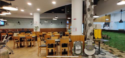 a restaurant with wooden tables and chairs and a cafeteria at Ocean Dream Apartment- Air Condition in Funchal