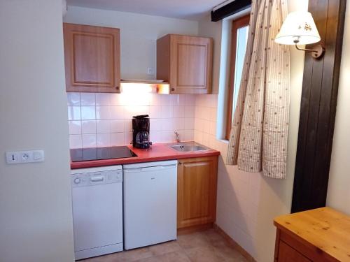 La cuisine est équipée d'un évier et d'un lave-vaisselle blanc. dans l'établissement Apartment in Termignon with Ski-In Ski-Out, à Val Cenis