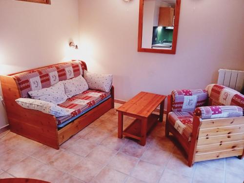 a living room with a couch and a table at Holiday home in Val Cenis for 4 people in Val Cenis